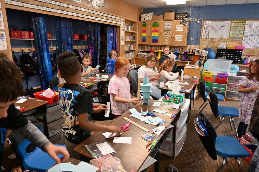 A student meets the challenge of her tower being taller than a ruler.