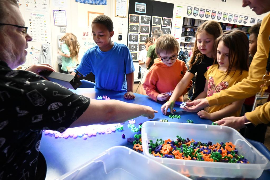 Students get parts for their spinners.