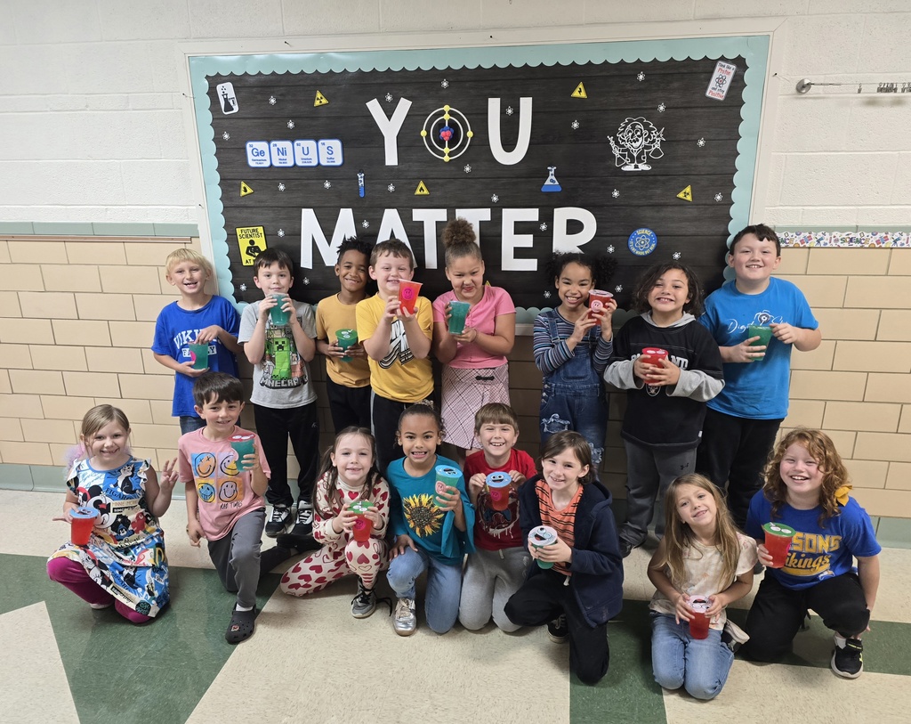 a group of students holding their drinks