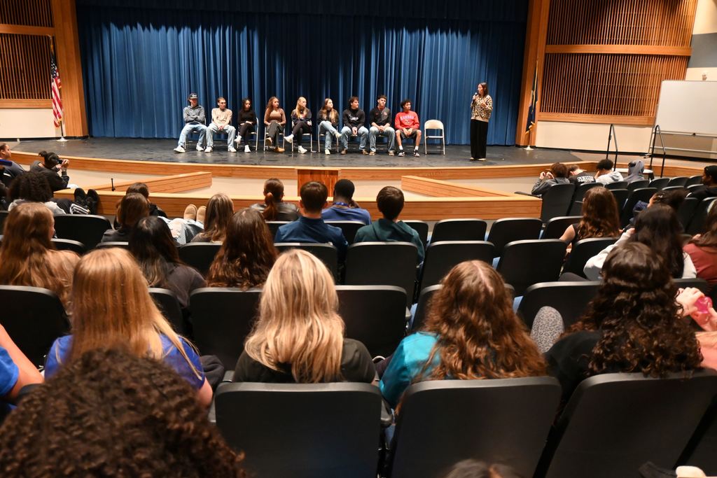 Kylie Lucas speaks to students about the grads who returned to share about their experiences.