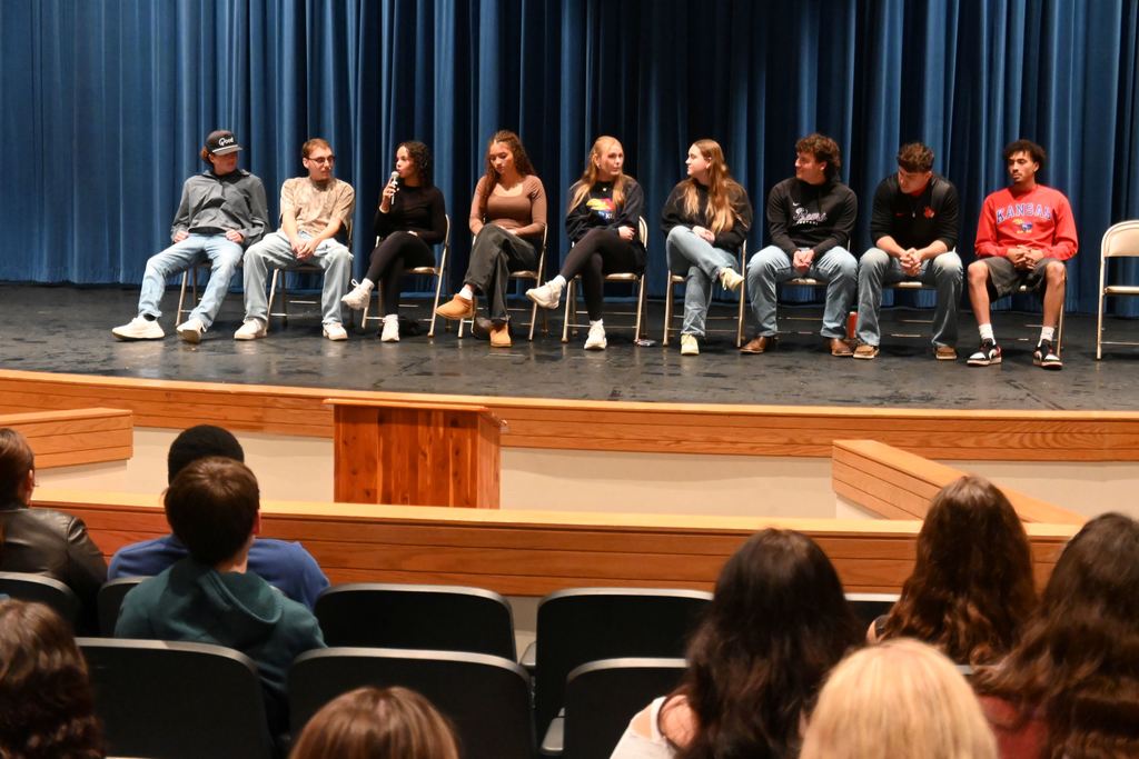 A grad speaks to students.