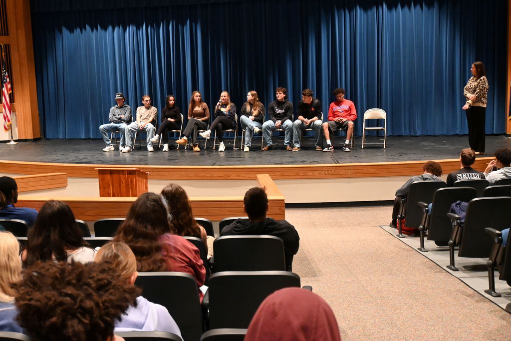 A grad speaks to students.