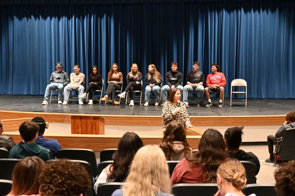 Kylie Lucas speaks to students about the grads who returned to share about their experiences.