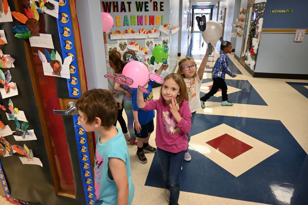 Guthridge first graders parade their balloons.