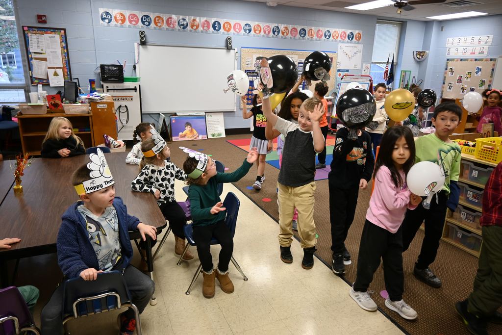 Guthridge first graders parade their balloons.