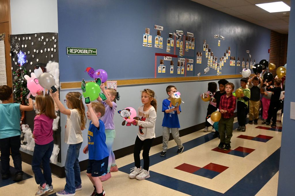 Guthridge first graders parade their balloons.
