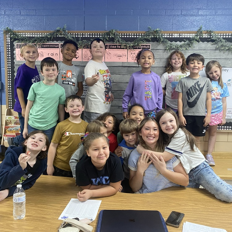 students gathered around an adult 