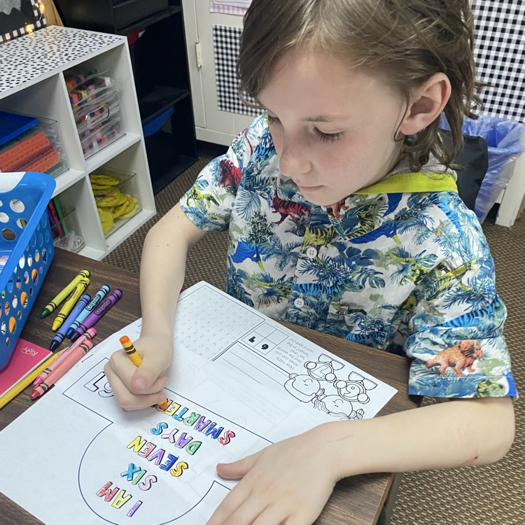 student coloring a headband 