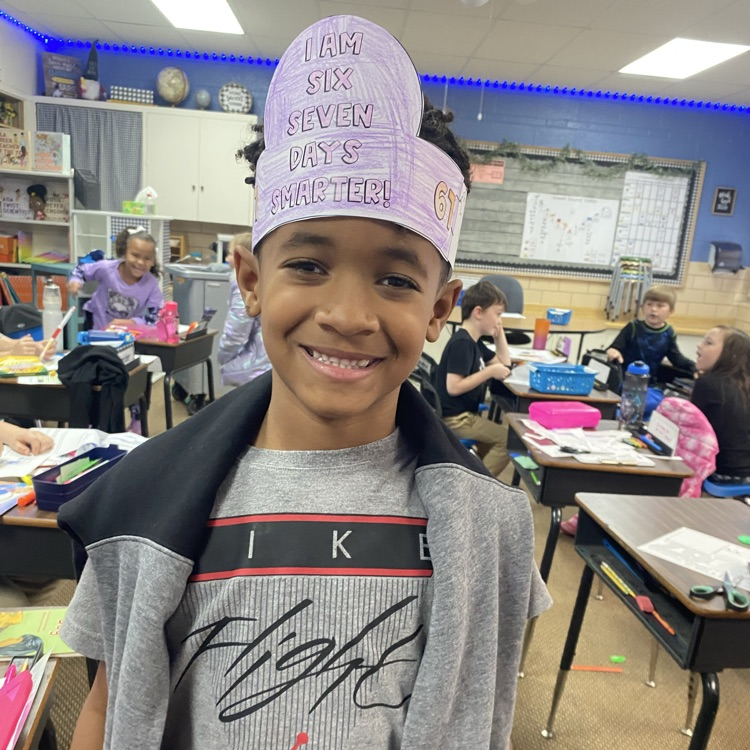 student wearing a headband that says I am 67 days smarter