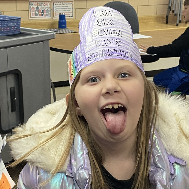 student wearing a headband that says I am 67 days smarter