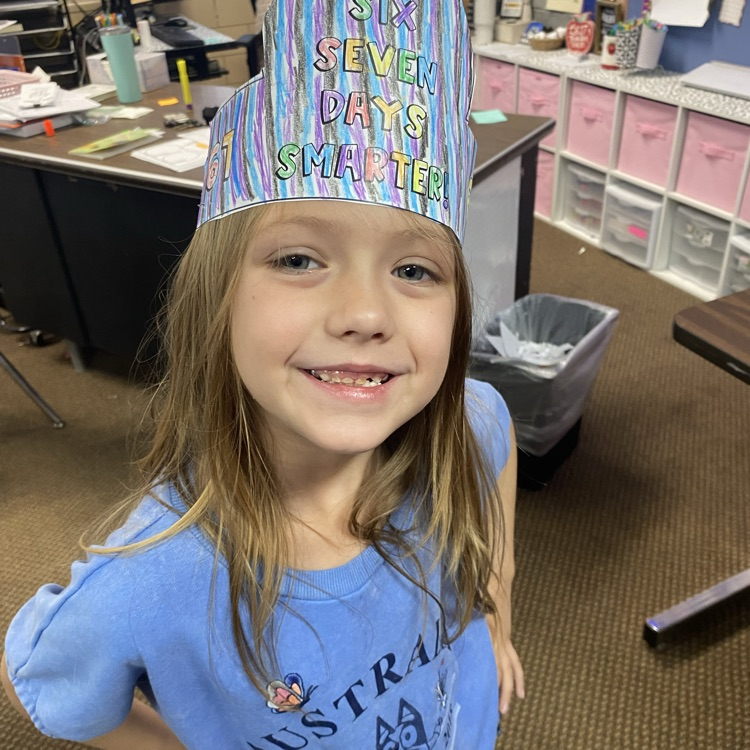 student wearing a headband that says I am 67 days smarter