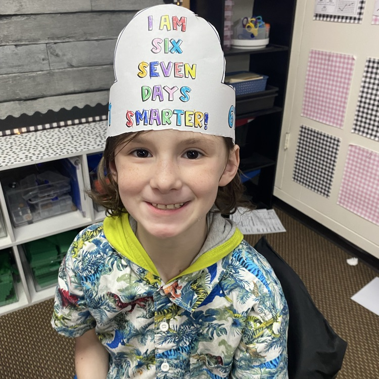 student wearing a headband that says I am 67 days smarter