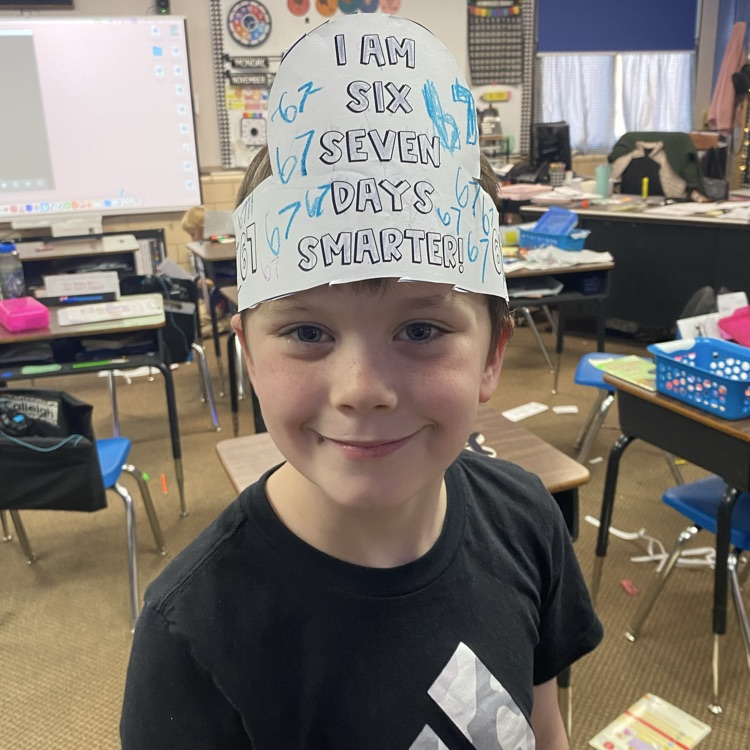 student wearing a headband that says I am 67 days smarter