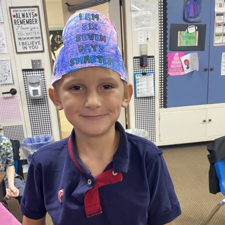 student wearing a headband that says I am 67 days smarter