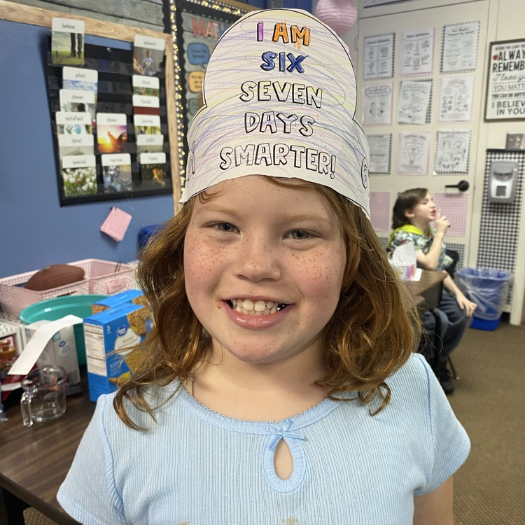 student wearing a headband that says I am 67 days smarter