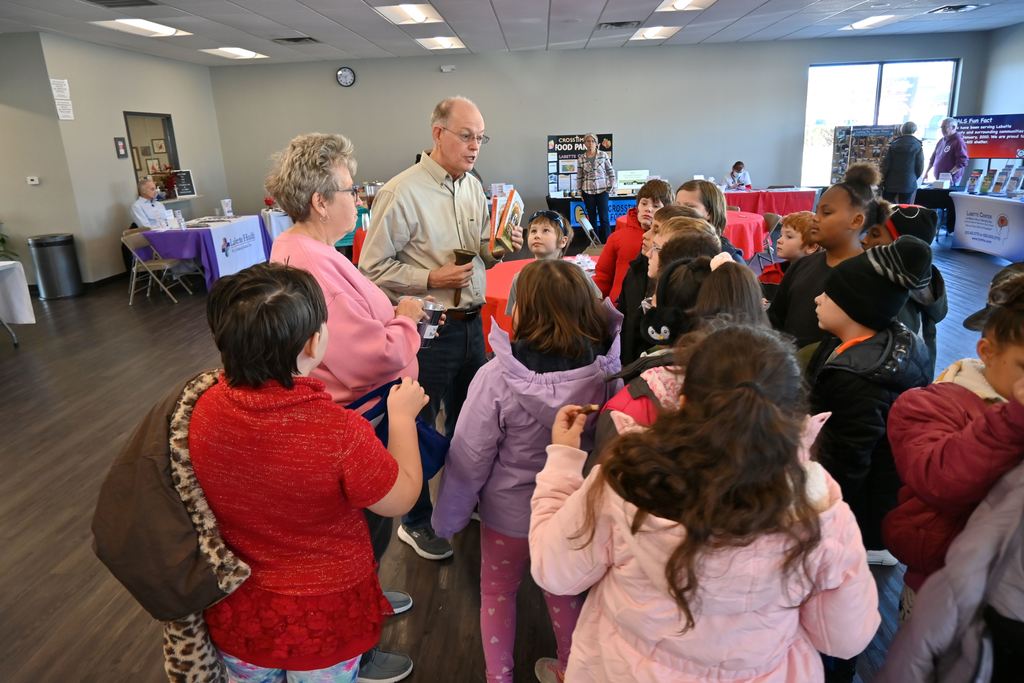 Oak Grove representatives hold a student drawing for two books.