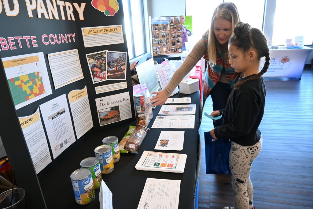 A student learn s about the Crosstimbers Food Pantry.