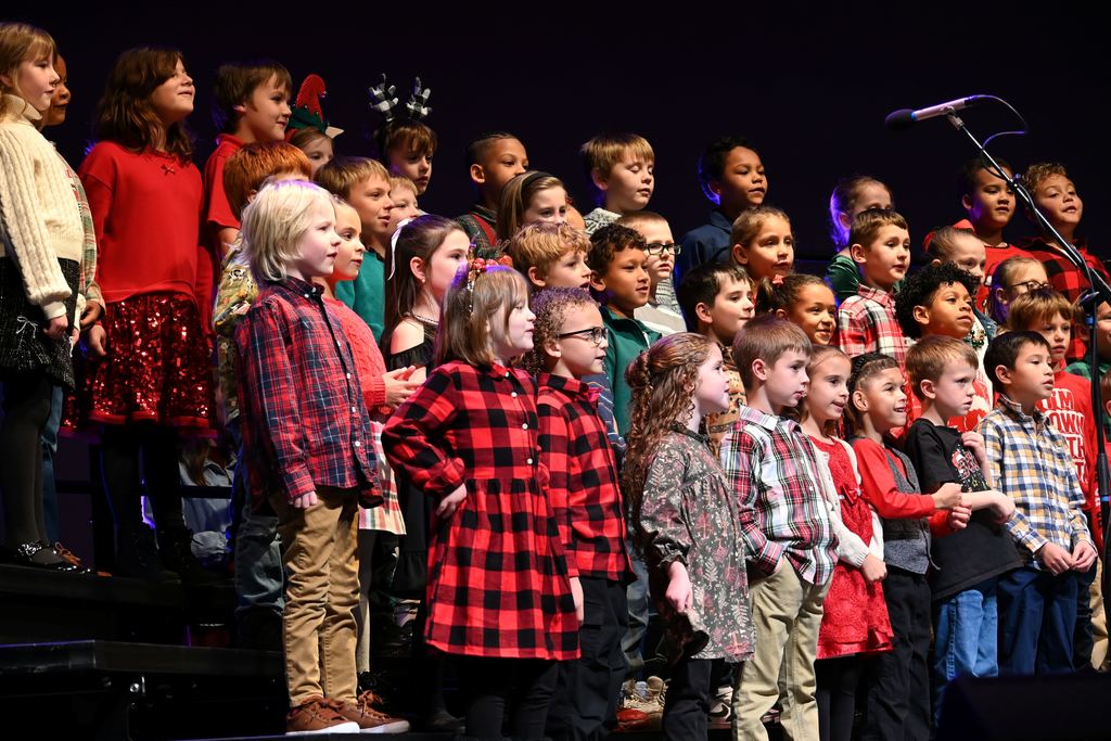 Lincoln children sing Christmas songs on stage.