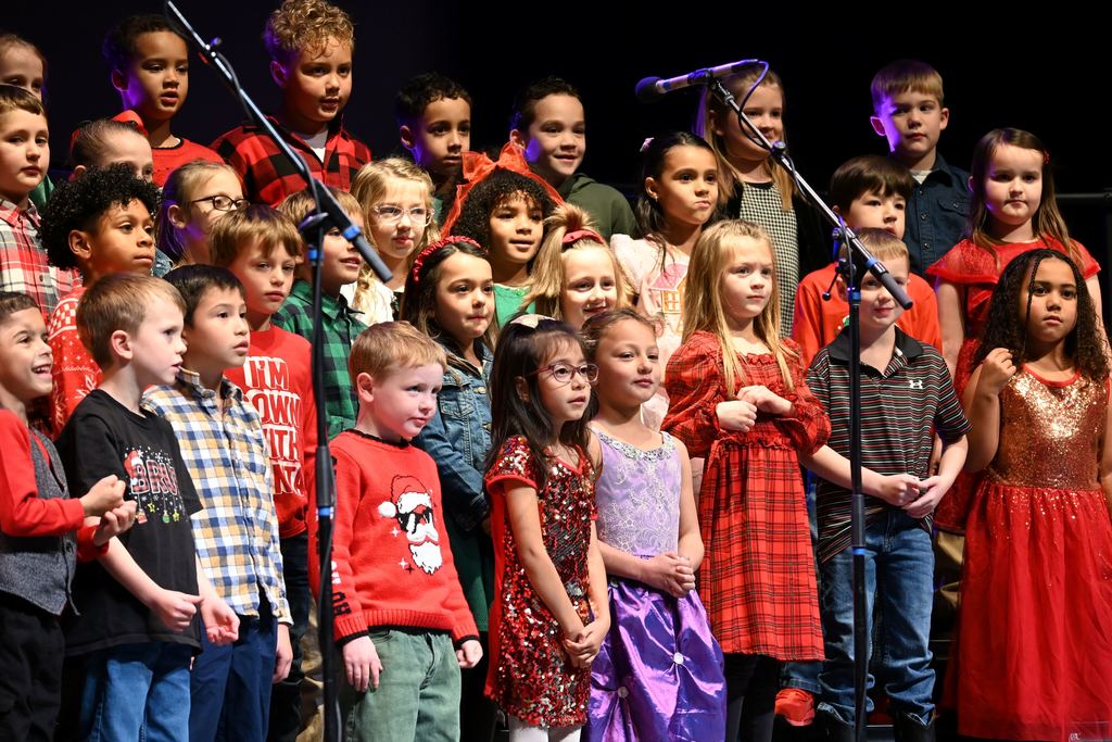 Lincoln children sing Christmas songs on stage.