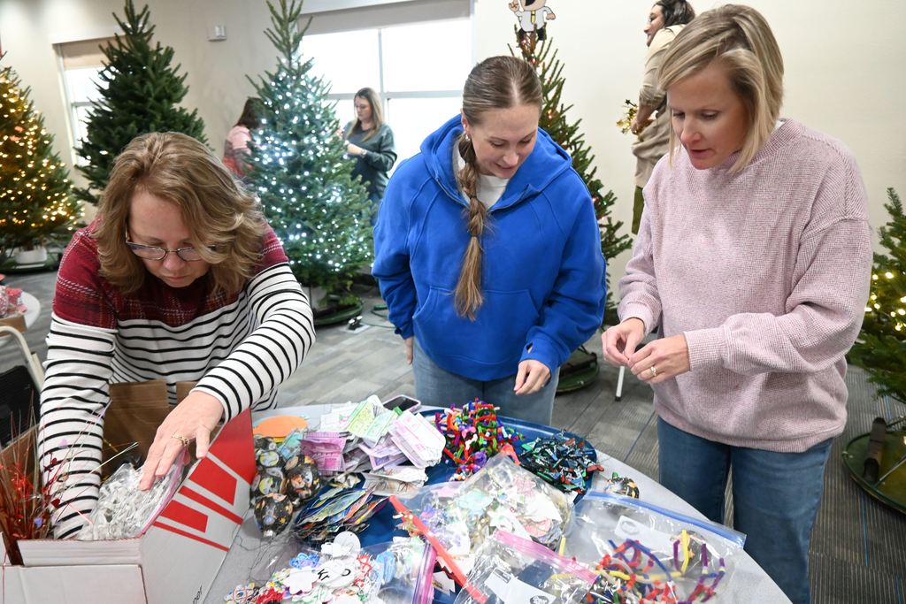 Staff organize decorations for the tree.
