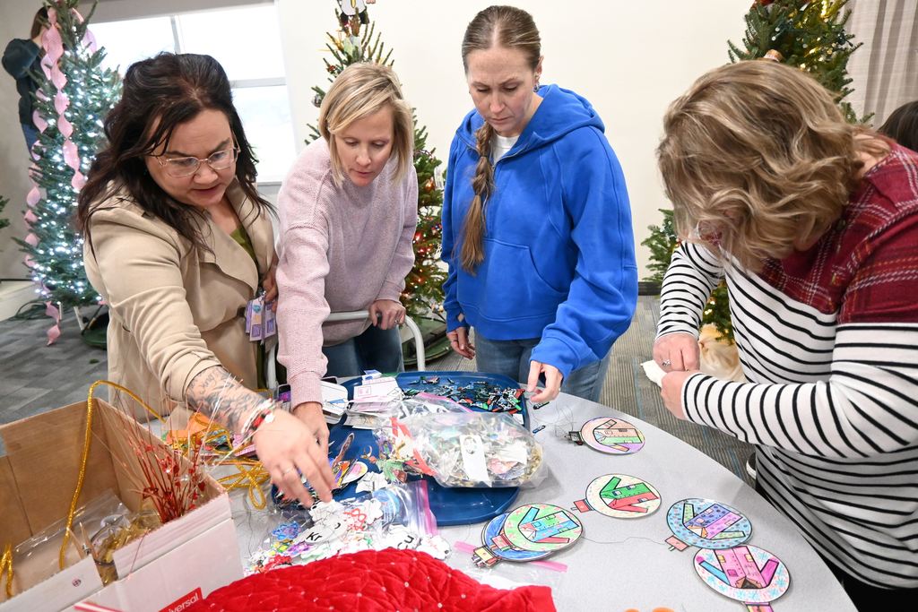 Staff organize decorations for the tree.