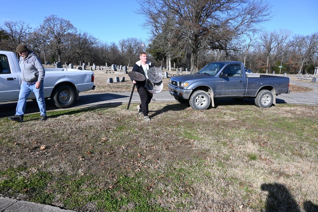 Athletes unload stands that will hold wreaths.