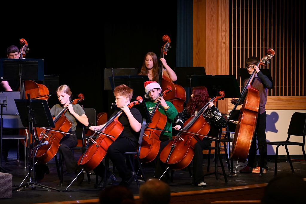 Orchestra students perform on stage.