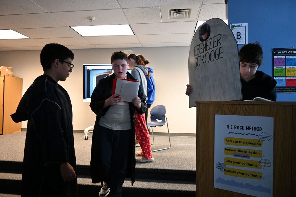 Students perform the play A Christmas Carol.