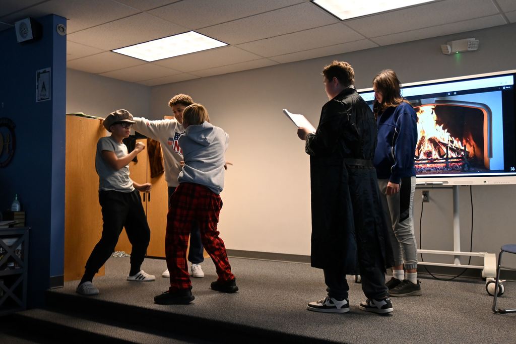 Students perform the play A Christmas Carol.