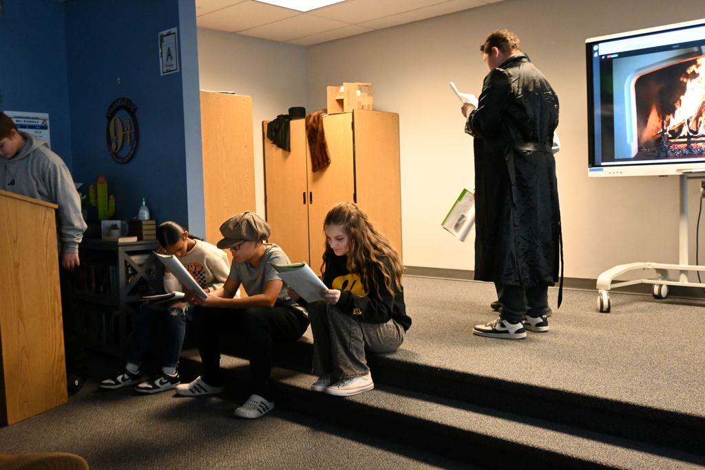 Students perform the play A Christmas Carol.
