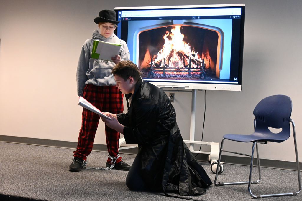 Students perform the play A Christmas Carol.