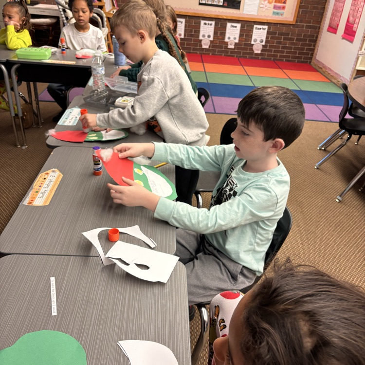 Students make a Grinch disguised as Santa. 