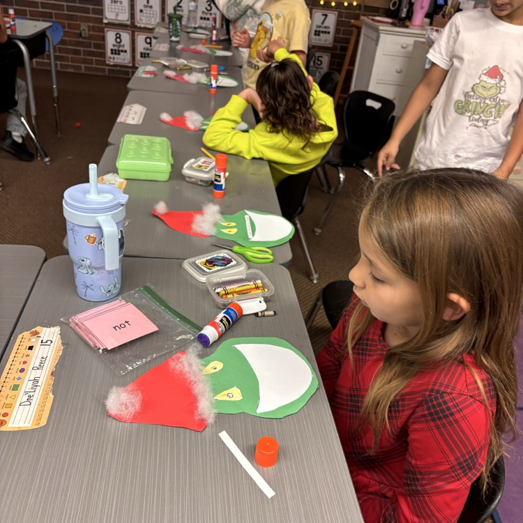 Students make a Grinch disguised as Santa. 