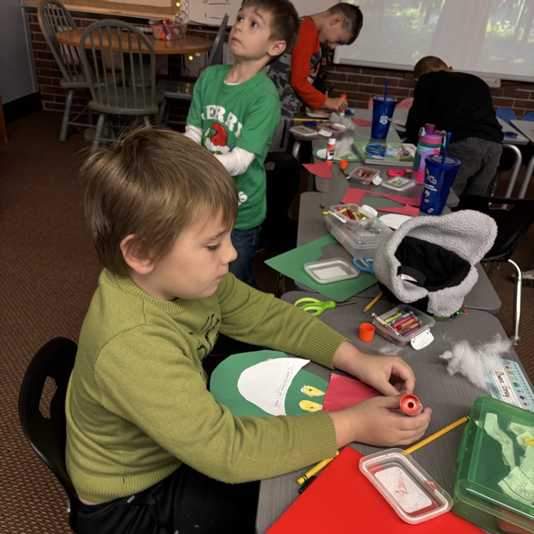 Students make a Grinch disguised as Santa. 