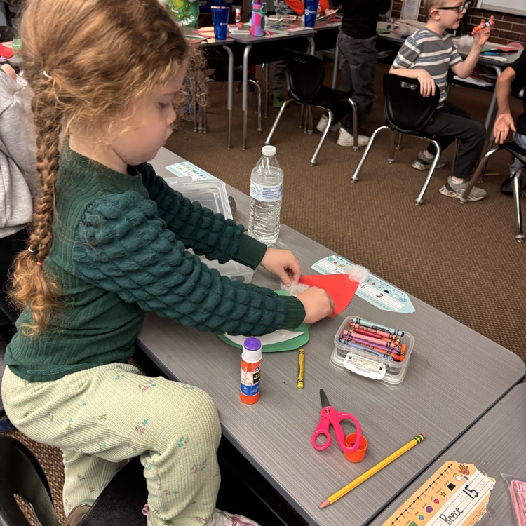 Students make a Grinch disguised as Santa. 