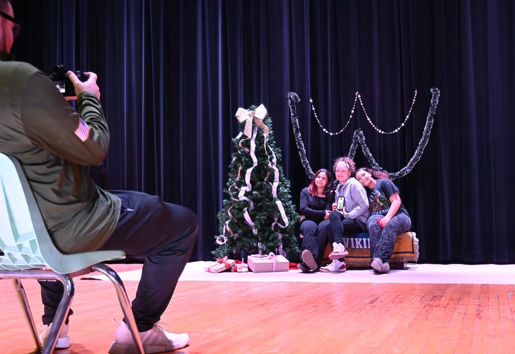 Sean Frye takes a photo of a family.