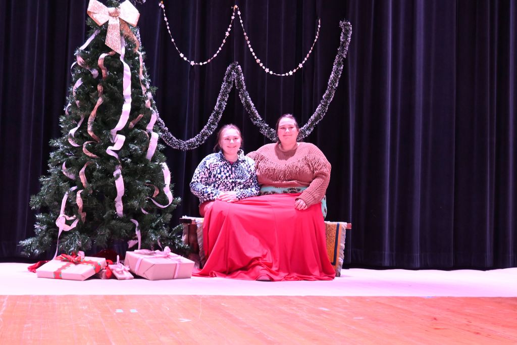 A mother and daughter pose for a photo..