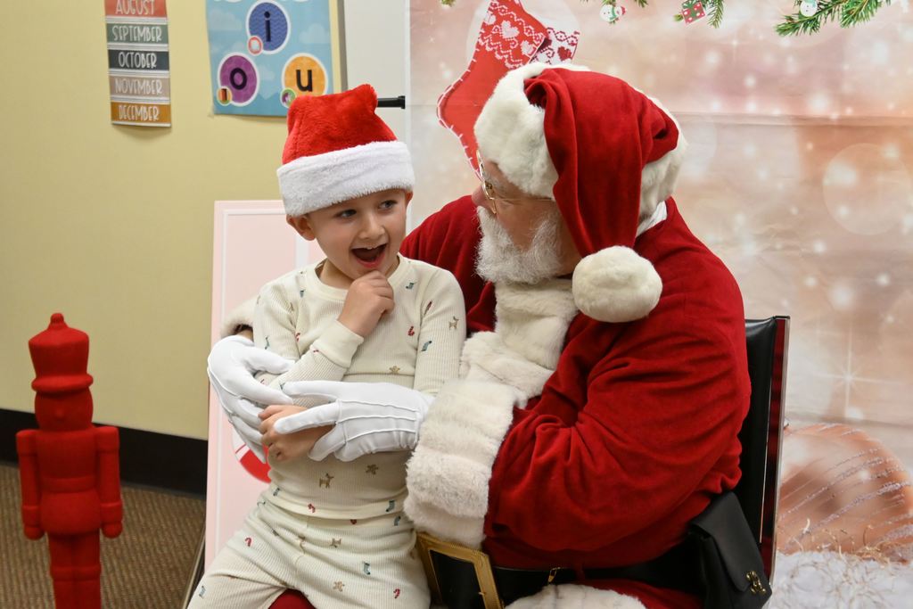 A little boy visits with Santa.