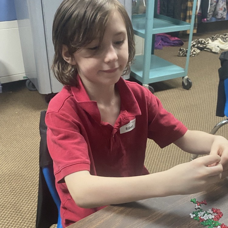 student making a beaded candy cane