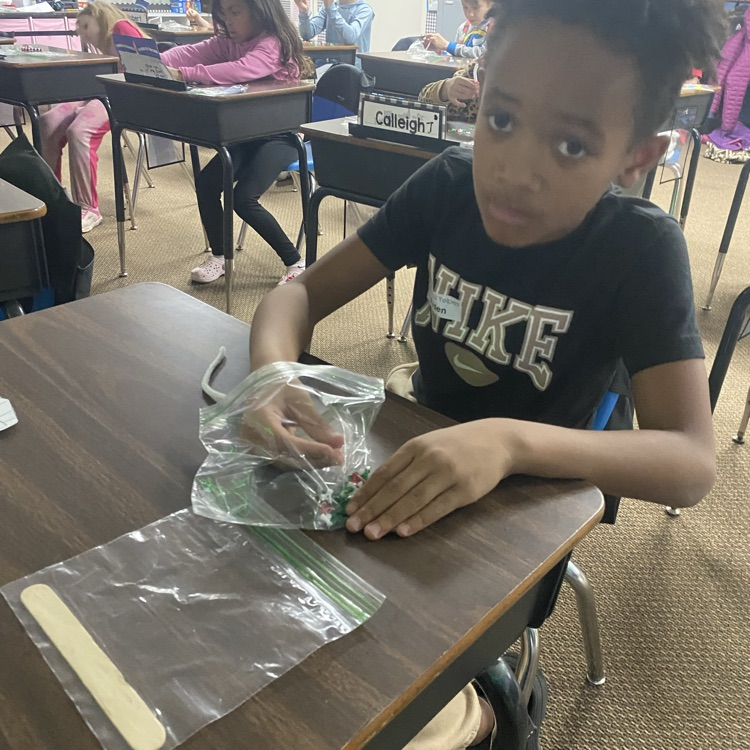 student making a beaded candy cane