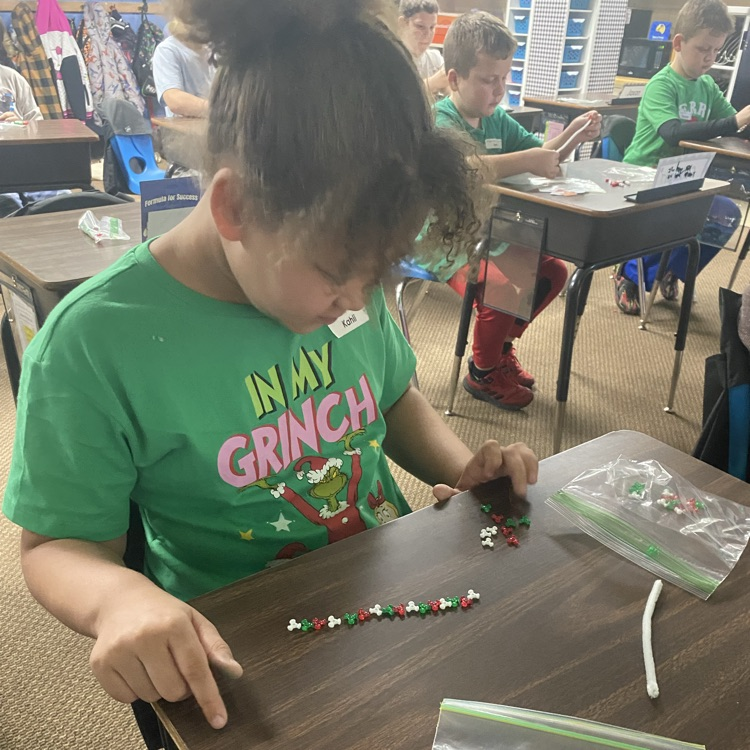 student making a beaded candy cane