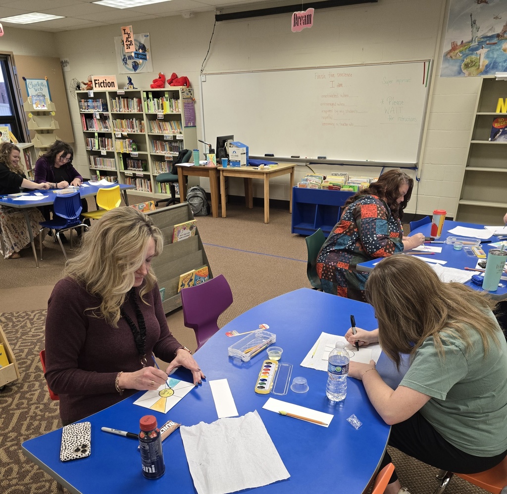 teachers working on artwork designs