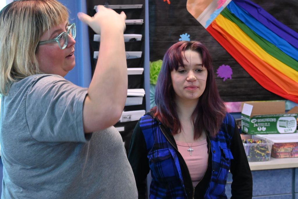 Miss Vincent, with the assistance of a student volunteer, demonstrates to students a hands-on lesson in breaking down facial features s and proportions.