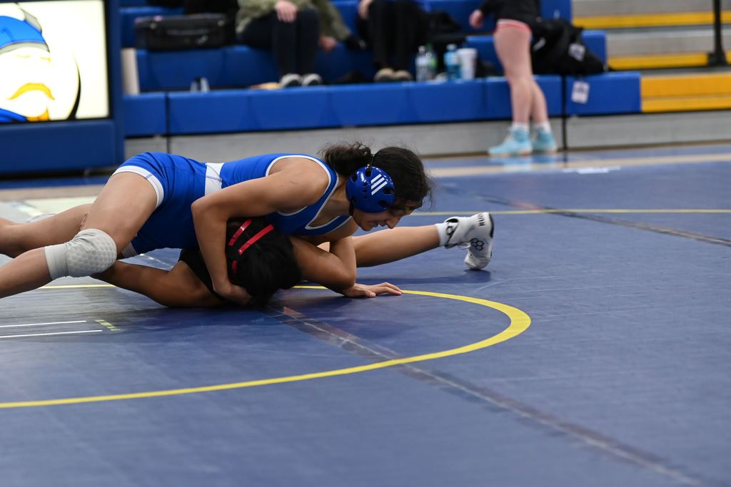 A female wrestler from Parsons and another from Erie wrestle.