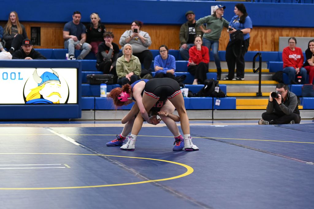 A female wrestler from Parsons and another from Erie wrestle.