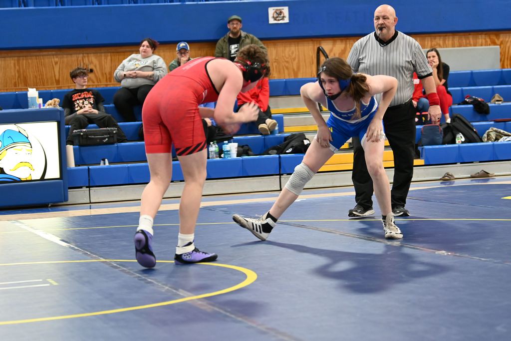 A wrestler from Erie and Parsons size each other up as they start.