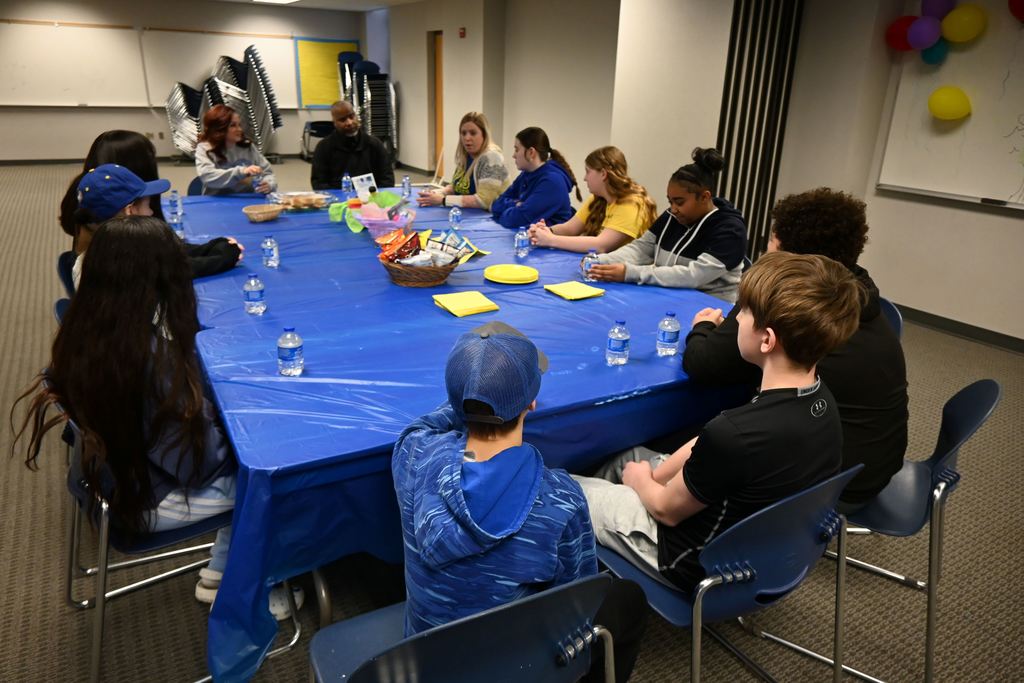Students ask questions of board members then enjoy lunch together.