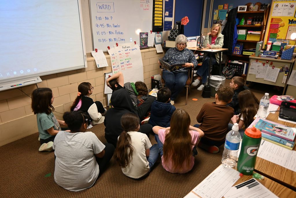 Board member Lee Ann Hunter reads to Mrs. Keal's third grade class.