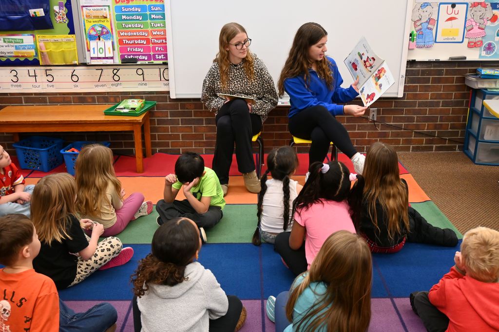 High School students read to elementary students.