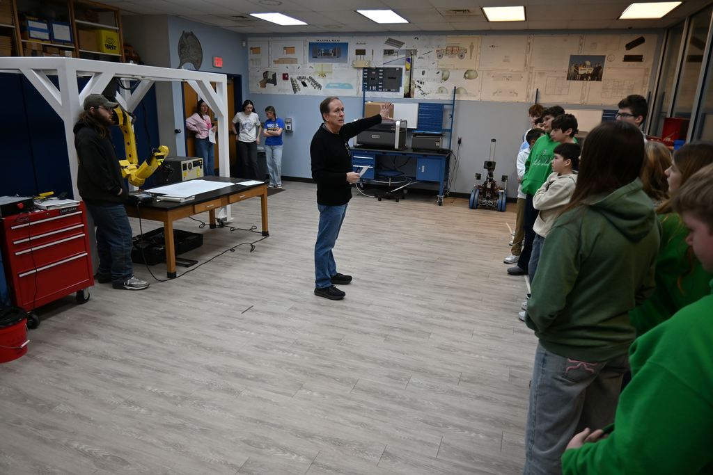 Bruce Rea talks to students about robotics.